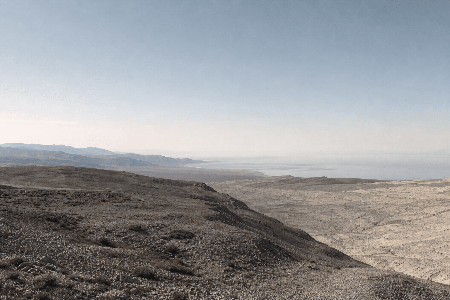 A distant horizon crossed by a restrained global route.